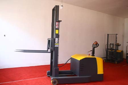 Stand-on reach electric stacker